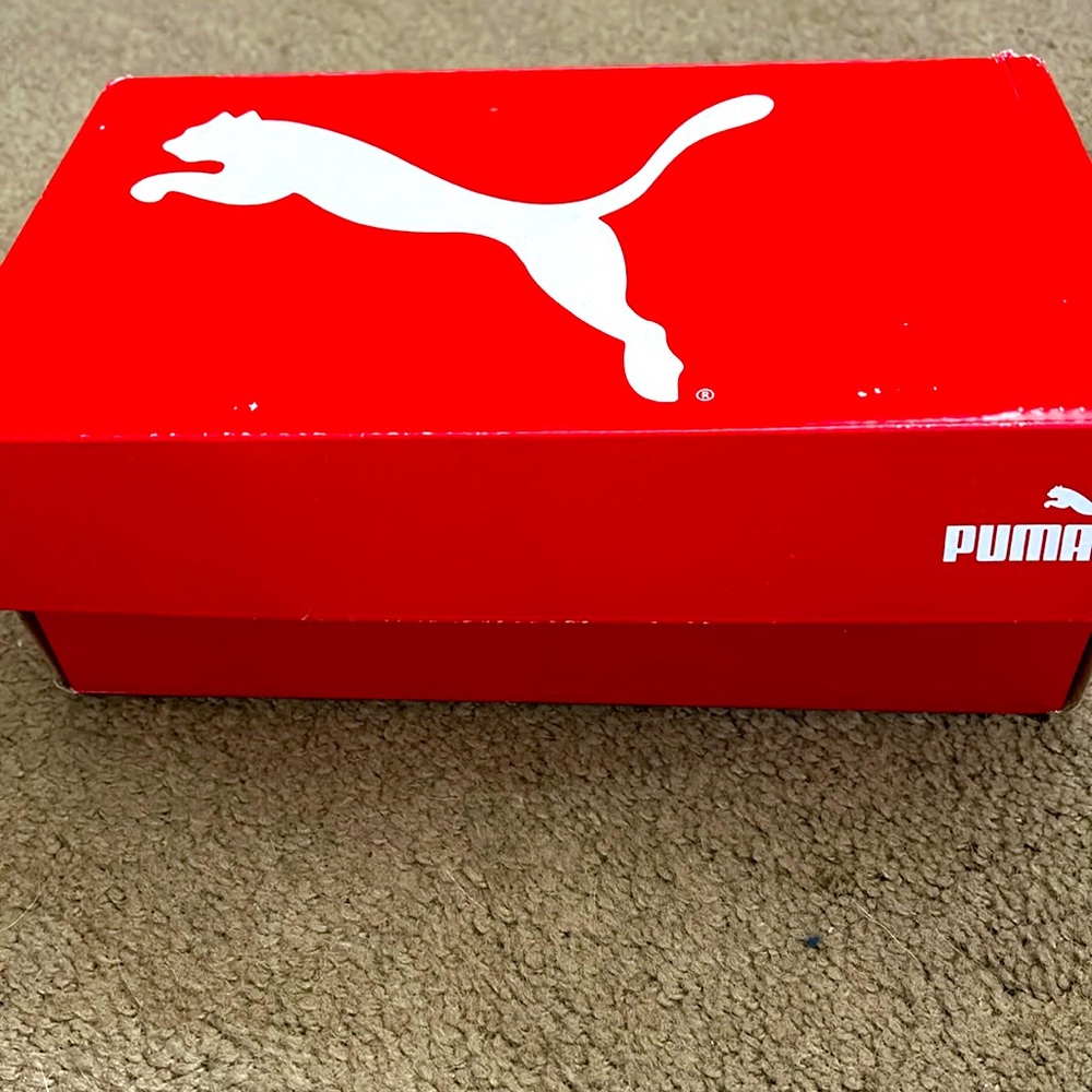 Brand new Puma “junior” sneakers. Size 4 1/2. Black.